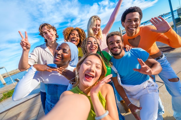 Happy and excited friends talking a selfie in the city