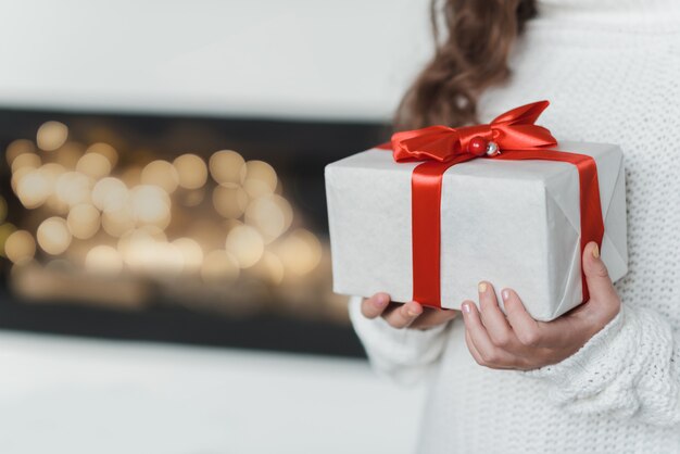 Happy excited girl child holding christmas gift box.