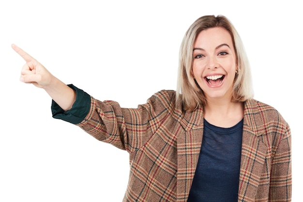 Photo happy excited and portrait of a smiling woman pointing isolated on a white background in studio direction advertisement and beautiful girl showing a recommendation or presenting on a backdrop