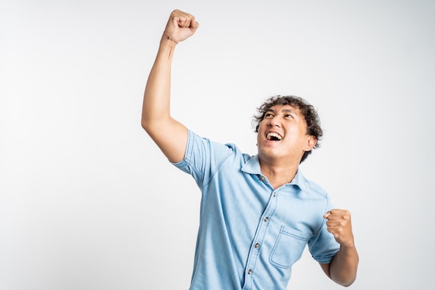 Happy excited young man over isolated background