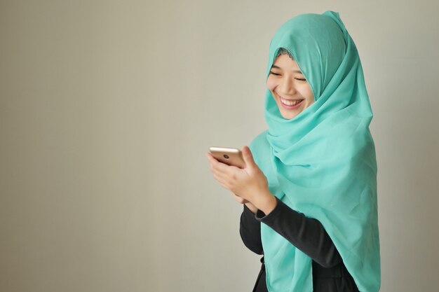 Happy exotic woman using smart phone