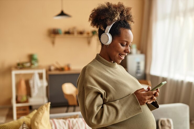 Happy expecting mother chatting online