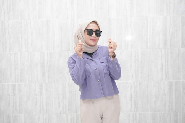 Happy expression of Indonesian Asian woman in hijab wearing blue clothes