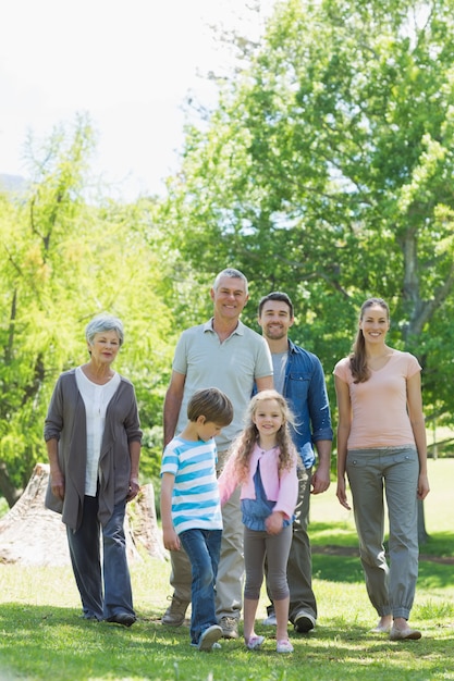 Happy extended family walking in park