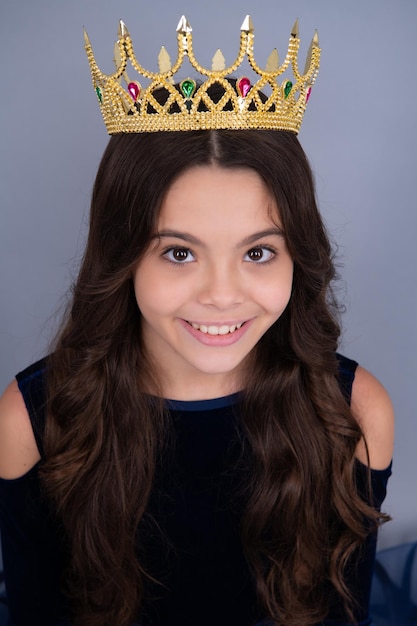 Happy face positive and smiling emotions of teenager girl
teenage selfish girl celebrates success victory teen child in queen
crown isolated on grey background princess in tiara prom party