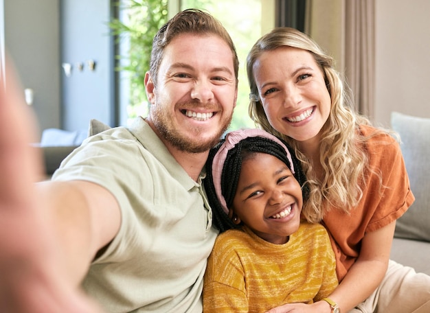 Happy family adoption and smile for selfie love relax or bonding in happiness together at home Mother father and adopted child smiling or relaxing for photo moment or capture on living room couch