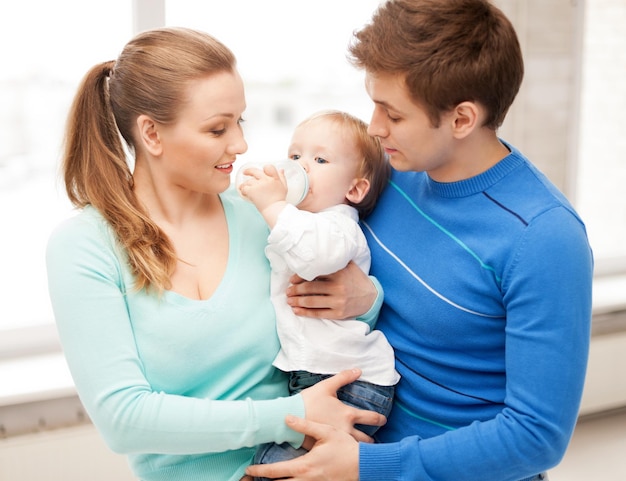 happy family and adorable baby with feeding-bottle