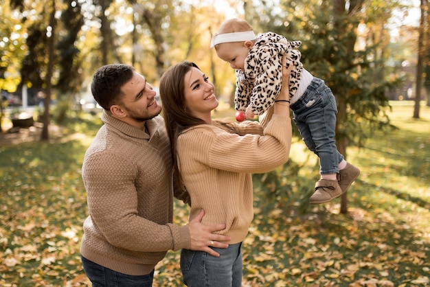 Happy family in the autumn park laughing