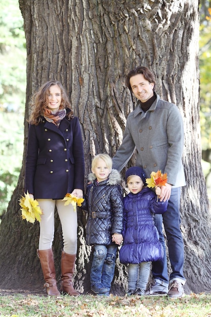 Happy family in autumn park