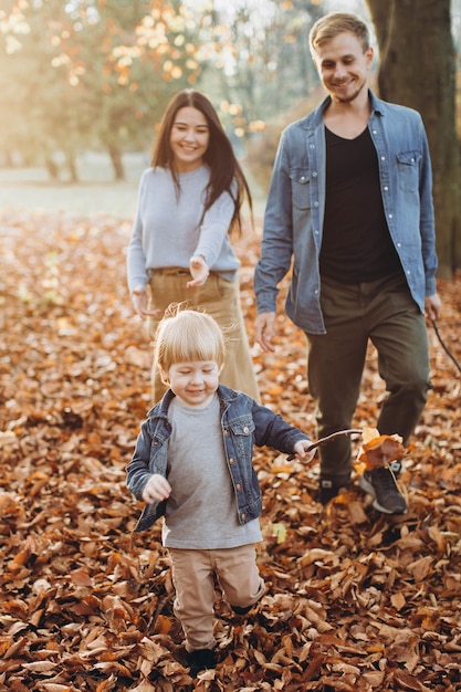 Happy family in autumn park