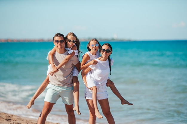 Famiglia felice sulla spiaggia durante le vacanze estive