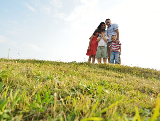 Happy family on beautiful summer meadow having happy time