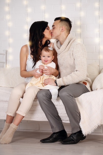 Happy Family in bed playing and kissing