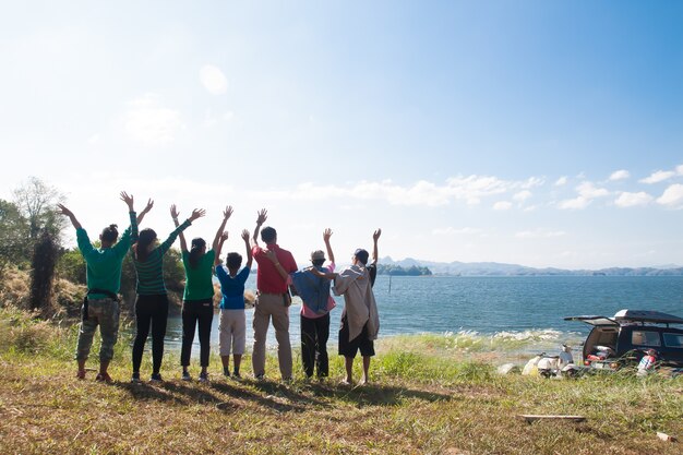 Photo happy family, big family variety of generation standing by the lake 