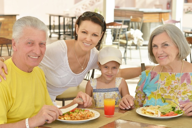 Happy family at breakfast on tropical resort