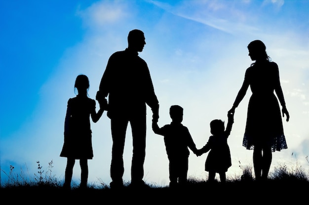 Happy family by the sea on nature silhouette background