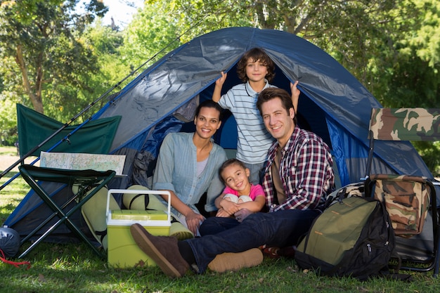 Happy family on a camping trip in their tent