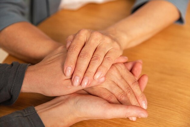 Happy family caring woman hands holding hands loving older woman mother grown up daughter and mom