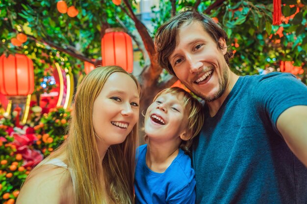 Happy family celebrate chinese new year look at chinese red lanterns