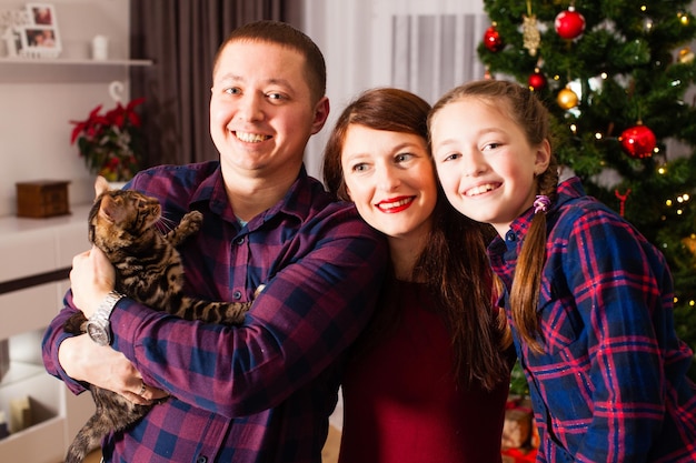 Happy family celebrate Christmas holidays at home Best gift at Christmas is little kitten