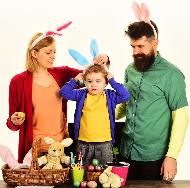 Happy family celebrate easter mother father and son with colored eggs rabbit family