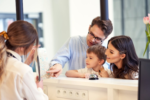 happy family checking in hotel