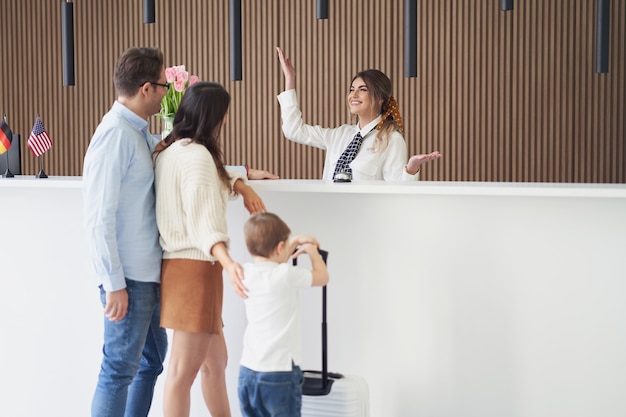 happy family checking in hotel