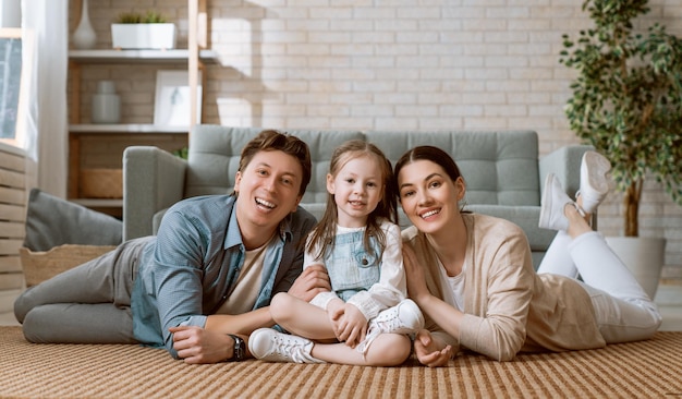 Photo happy family! child daughter with mother and father. mum, dad and girl laughing and hugging.