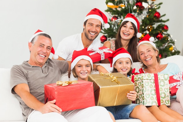 Happy family at christmas holding gifts