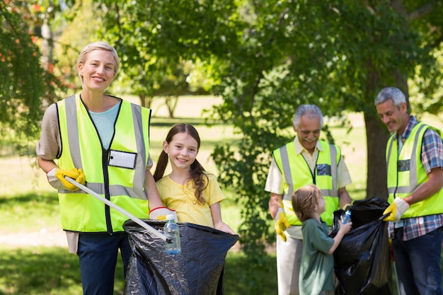 Photo happy family collecting rubbish