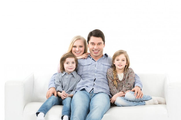 Happy family on the couch isolated