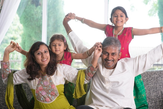 Photo happy family on couch in living room at home