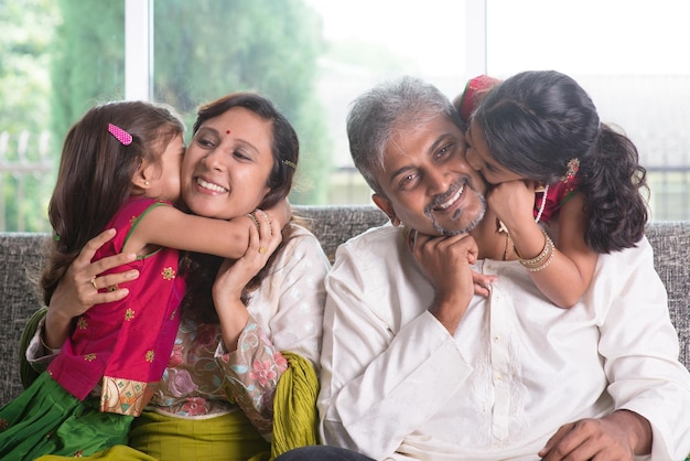 Photo happy family on couch in living room at home