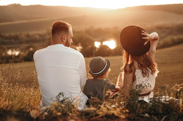 Happy family in countryside at sunset