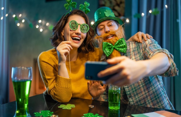 Happy family couple celebrating St Patricks Day