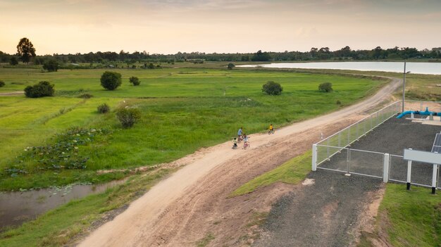 Happy family cycling on bikes outdoors, active parents with children have fun, family sport and fitness, aerial view from above