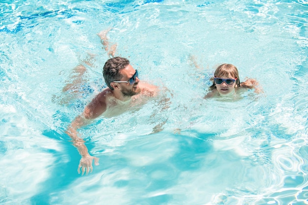 Happy family of dad and kid having fun in summer swimming pool summer holiday