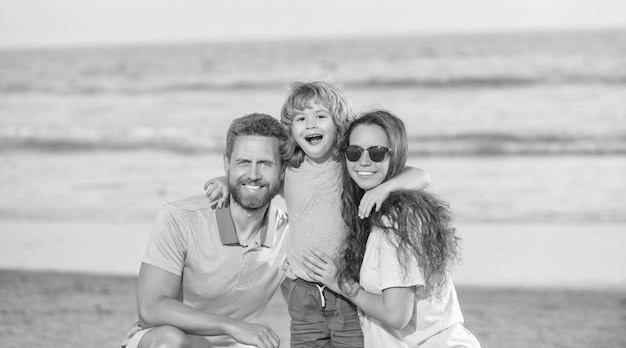 Happy family of dad mom and son on summer beach