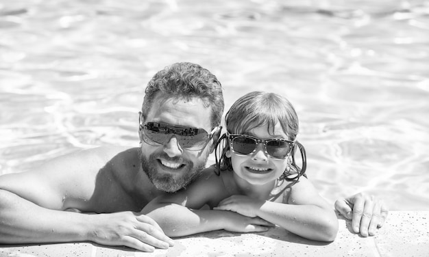 Happy family of daddy and little boy having fun in summer swimming pool family