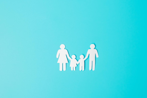 happy family day paper shape cutout with father mother and children international day of families warm home homeless foster insurance charity and donation concepts