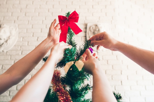 Happy family decorating Christmas tree