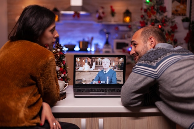 Happy family discussing with remote grandparent during online videocall