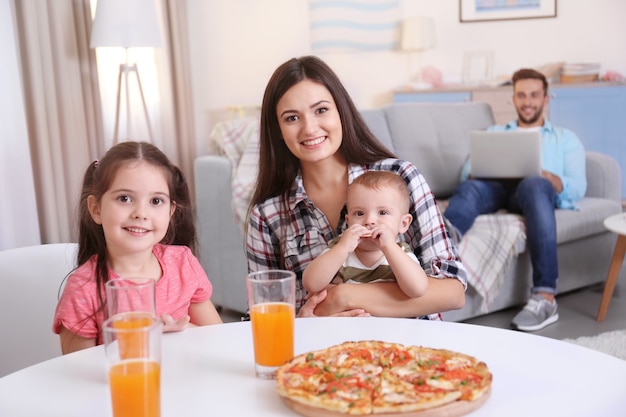 Happy family eating food on kitchen