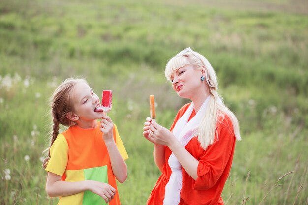 Happy family eating ice-cream outdoors