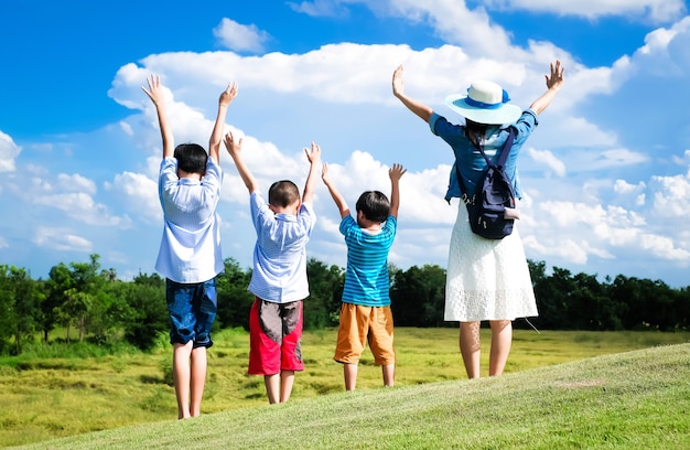 Happy family enjoying on the field during vacation.