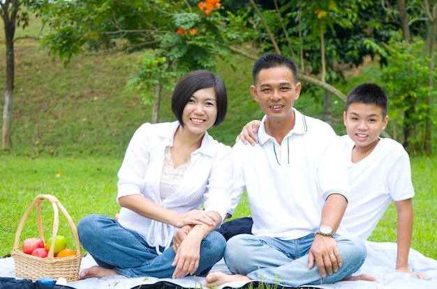 Happy family enjoying picnic in park