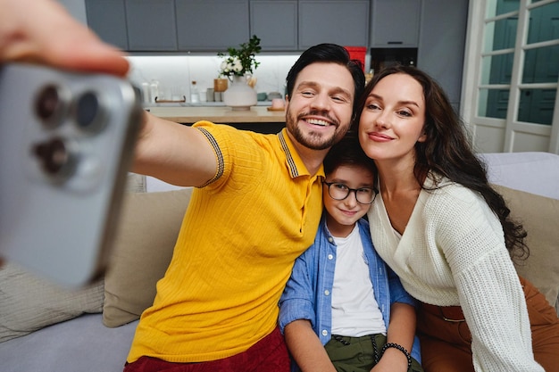 A happy family enjoys quality time together while taking selfies