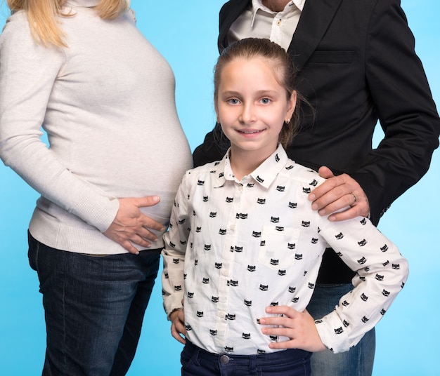 Happy family. Family studio shot on a blue wall