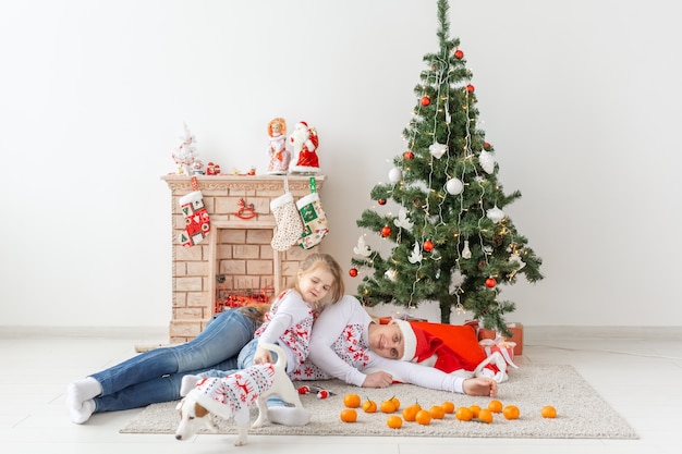 Happy family. Father and child at christmas tree at home