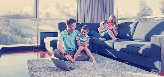 Happy family. Father, mother and children playing a video game Father and son playing video games together on the floor